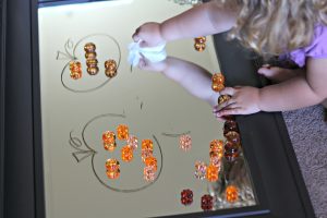 Erasing the pumpkins with a baby wipe - Happily Ever Mom